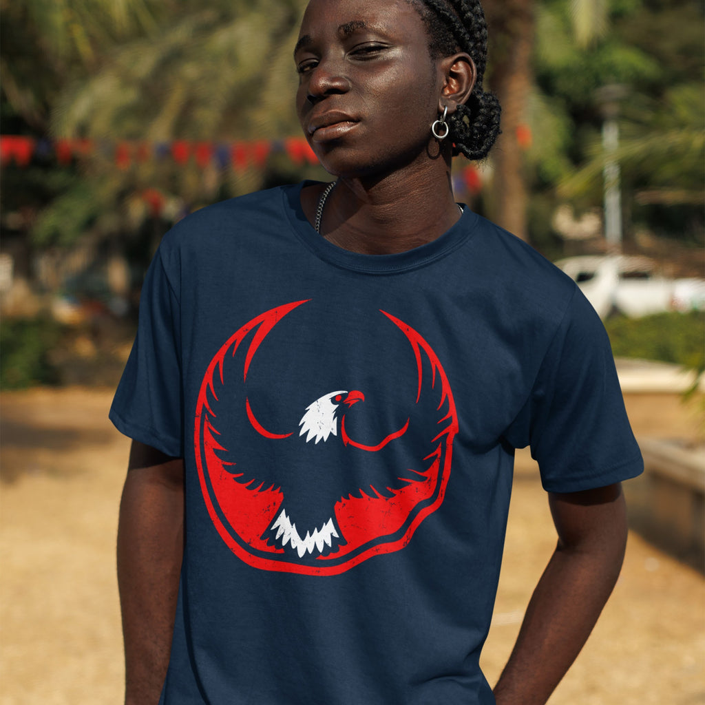 A young person models the USA Rebel Alliance T-shirt, featuring a bold eagle graphic, embodying anti-fascist and equality themes, complemented by braided hair, hoop earring, and chain necklace.
