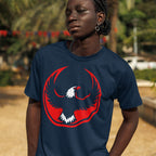 A young person models the USA Rebel Alliance T-shirt, featuring a bold eagle graphic, embodying anti-fascist and equality themes, complemented by braided hair, hoop earring, and chain necklace.