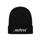 Black rib-knit beanie, labeled Useless in white Old English letters, flanked by yellow starbursts; embodies relaxation and re