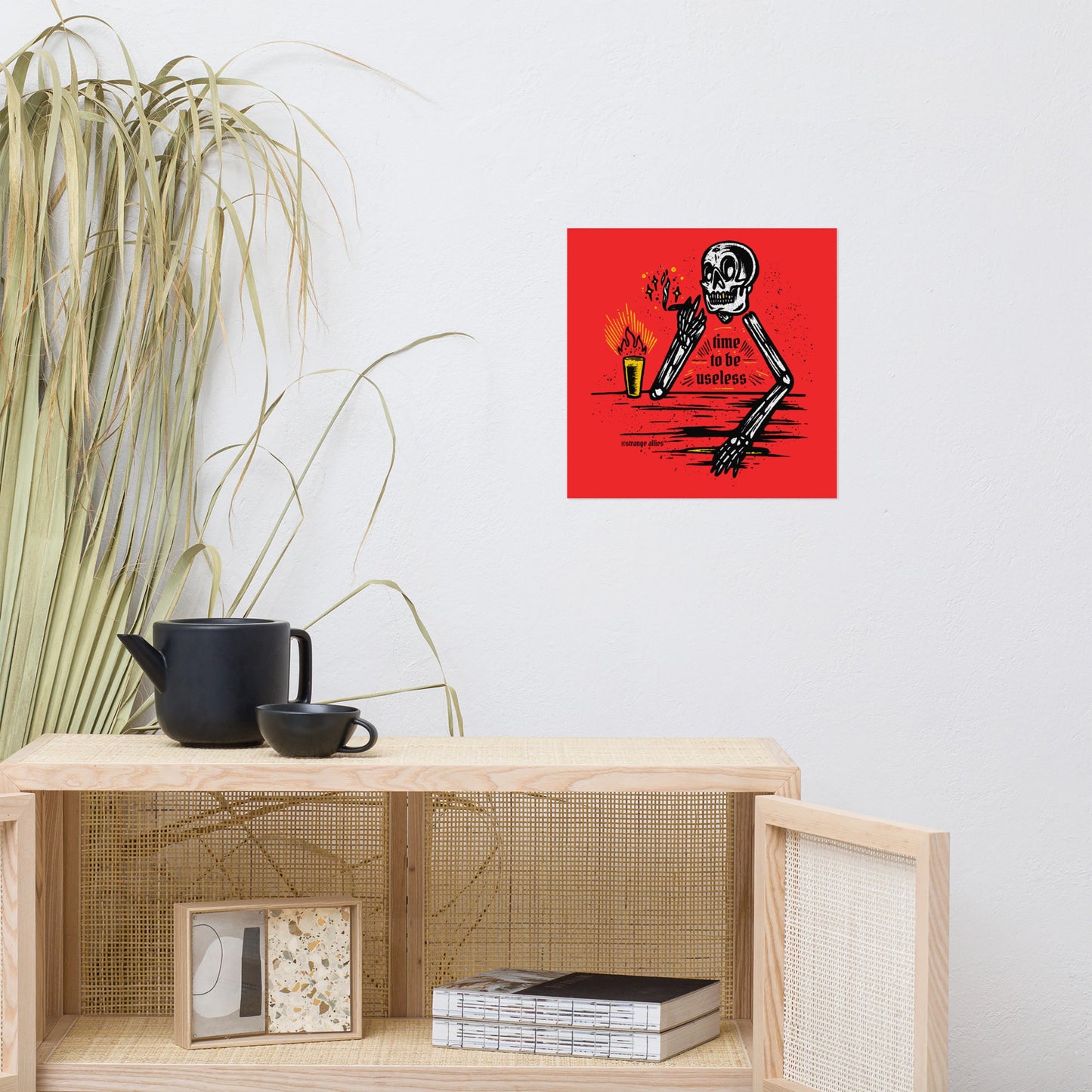 Useless Giclée Print features a cartoon skeleton with a flaming drink and the phrase time to be useless, embodying a playful, rebellious spirit. Available in various sizes for artistic expression.