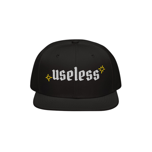 The Useless Hat features a flat-bill snapback design, with useless embroidered in white Old English font, flanked by yellow s