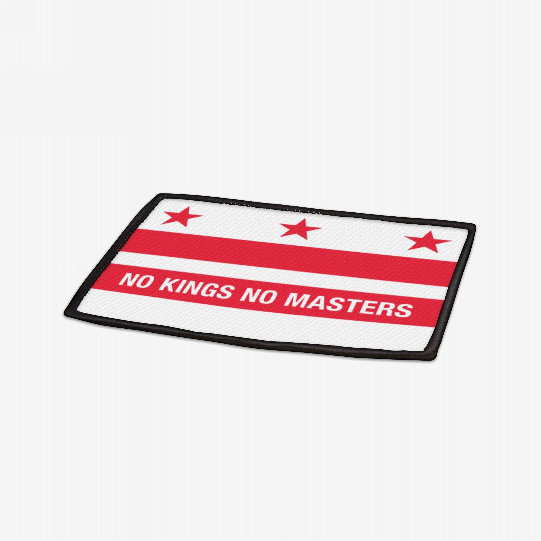 Washington DC Flag No Kings Patch featuring three red stars and two red bars, with NO KINGS NO MASTERS on the lower bar, symbolizing resistance and equality. Iron-on polyester with black edges.