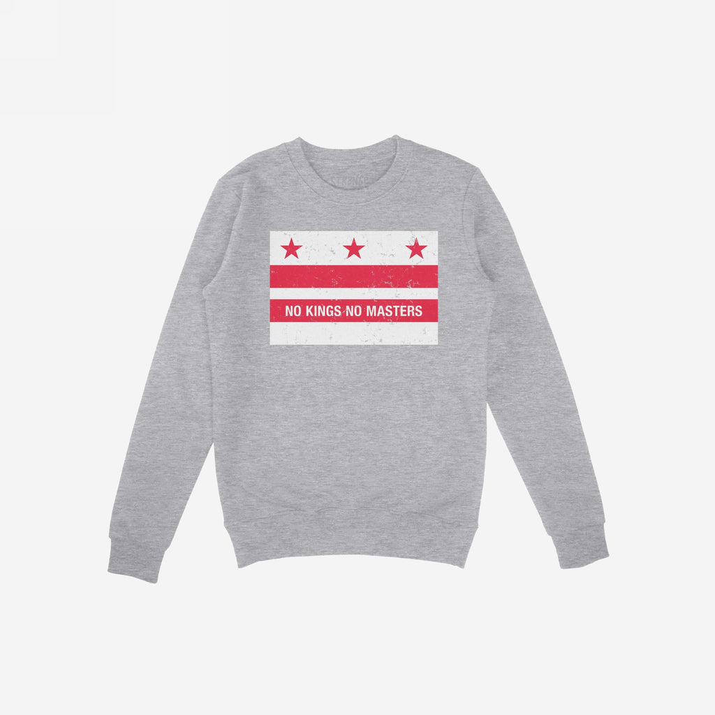 Light-gray crewneck sweatshirt featuring the Washington DC No Kings Flag Shirt design with distressed red stars, stripes, and the slogan “NO KINGS NO MASTERS” in white, symbolizing anti-authoritarian resistance.