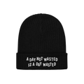 Black Wasted Days Hat with rib-knit design and folded cuff, featuring bold white embroidery: A DAY NOT WASTED IS A DAY WASTED