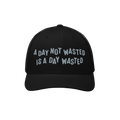 Wasted Days Hat featuring the phrase A Day Not Wasted Is A Day Wasted embroidered in a playful font on a black mesh-back truc