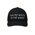 Wasted Days Hat featuring the phrase A Day Not Wasted Is A Day Wasted embroidered in a playful font on a black mesh-back truc