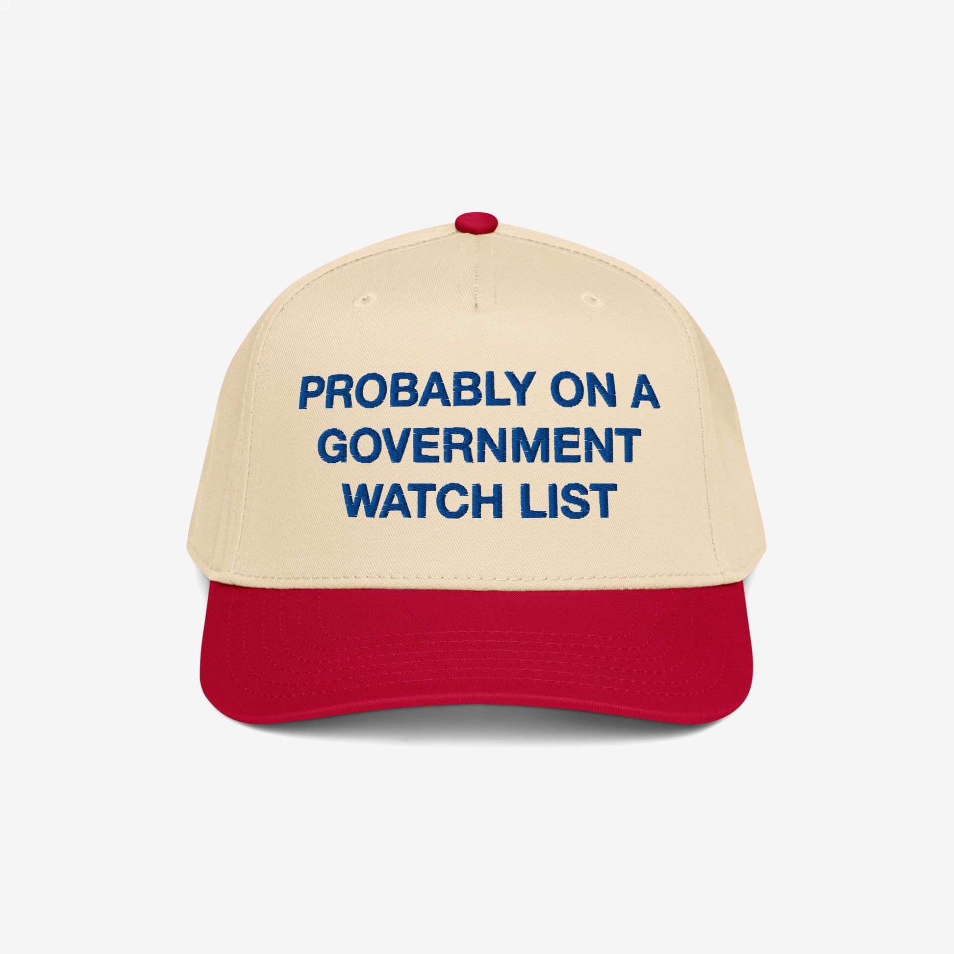 Watch List Hat with bold blue embroidery declaring “PROBABLY ON A GOVERNMENT WATCH LIST,” making a bold political statement. Beige crown and red bill offer a distinctive, eye-catching design.