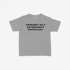 Watch List Women's Baby Tee featuring bold text “PROBABLY ON A GOVERNMENT WATCH LIST” on a light-gray background, offering a rebellious, feminist nod to activism and state surveillance challenges.
