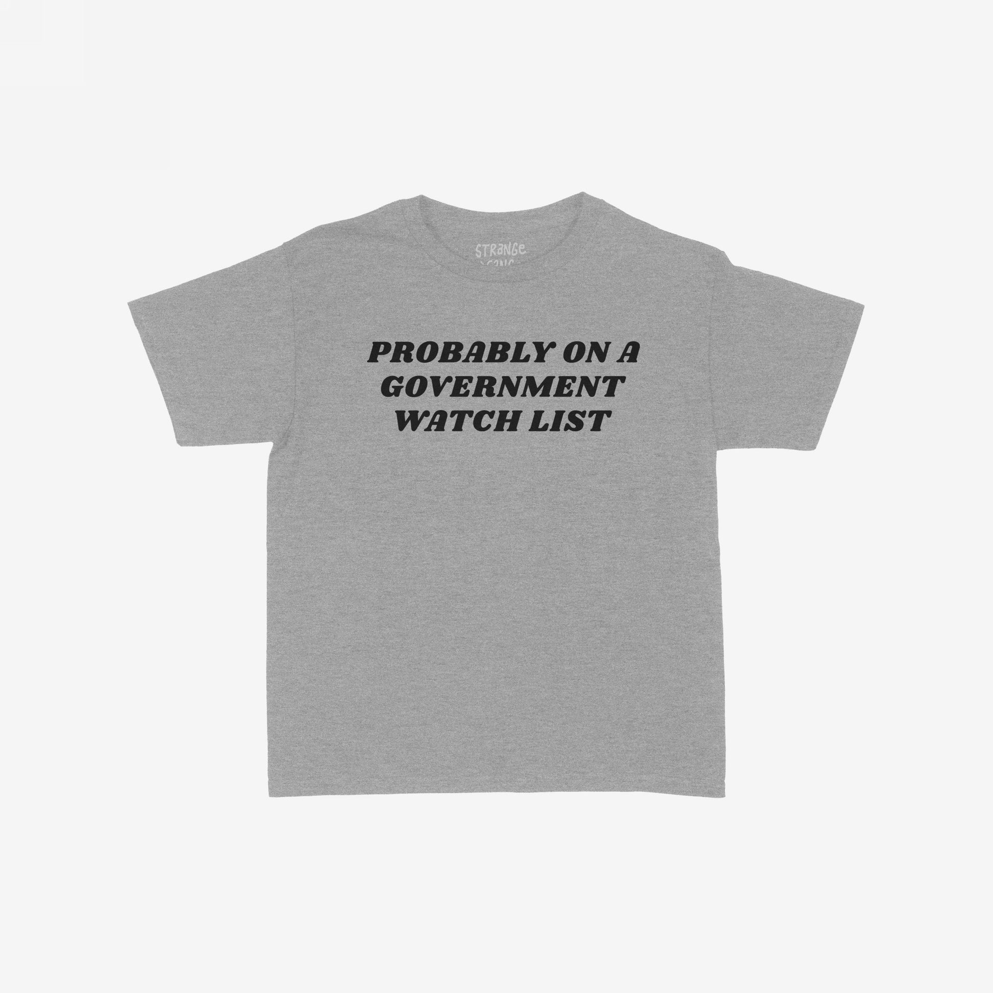 Heather-gray Watch List T-shirt featuring bold black text: “PROBABLY ON A GOVERNMENT WATCH LIST.” Faint branding inside neckline, reflecting bold resistance and unapologetic political stance.