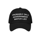 The Watch List Hat features a black baseball style with white embroidered text stating, PROBABLY ON A GOVERNMENT WATCH LIST, 