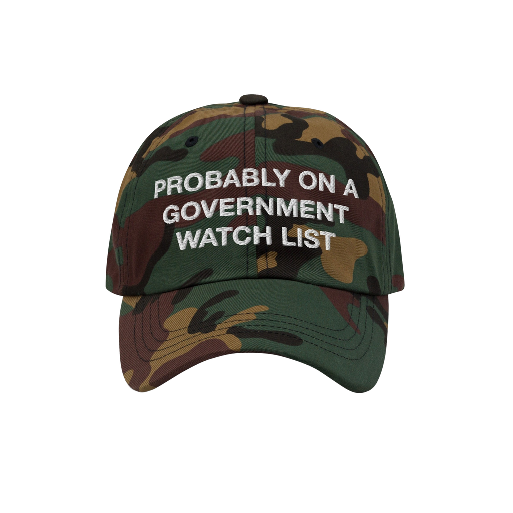 Watch List Hat: Six-panel baseball cap in woodland camo with “PROBABLY ON A GOVERNMENT WATCH LIST” stitched in white, fea