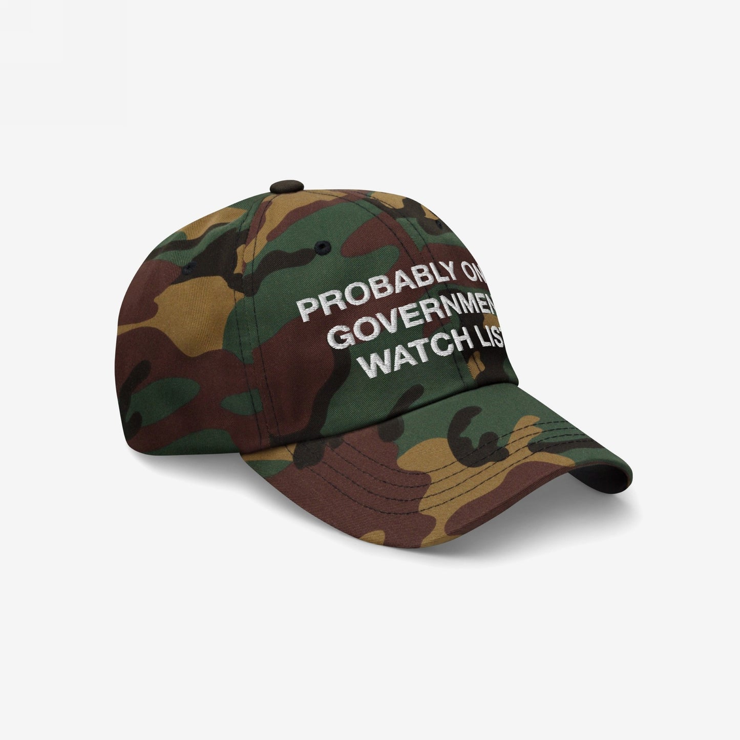 Watch List Hat featuring a woodland camouflage design with PROBABLY ON GOVERNMENT WATCH LIST embroidered in white, ideal for making a bold protest statement at marches or public gatherings.