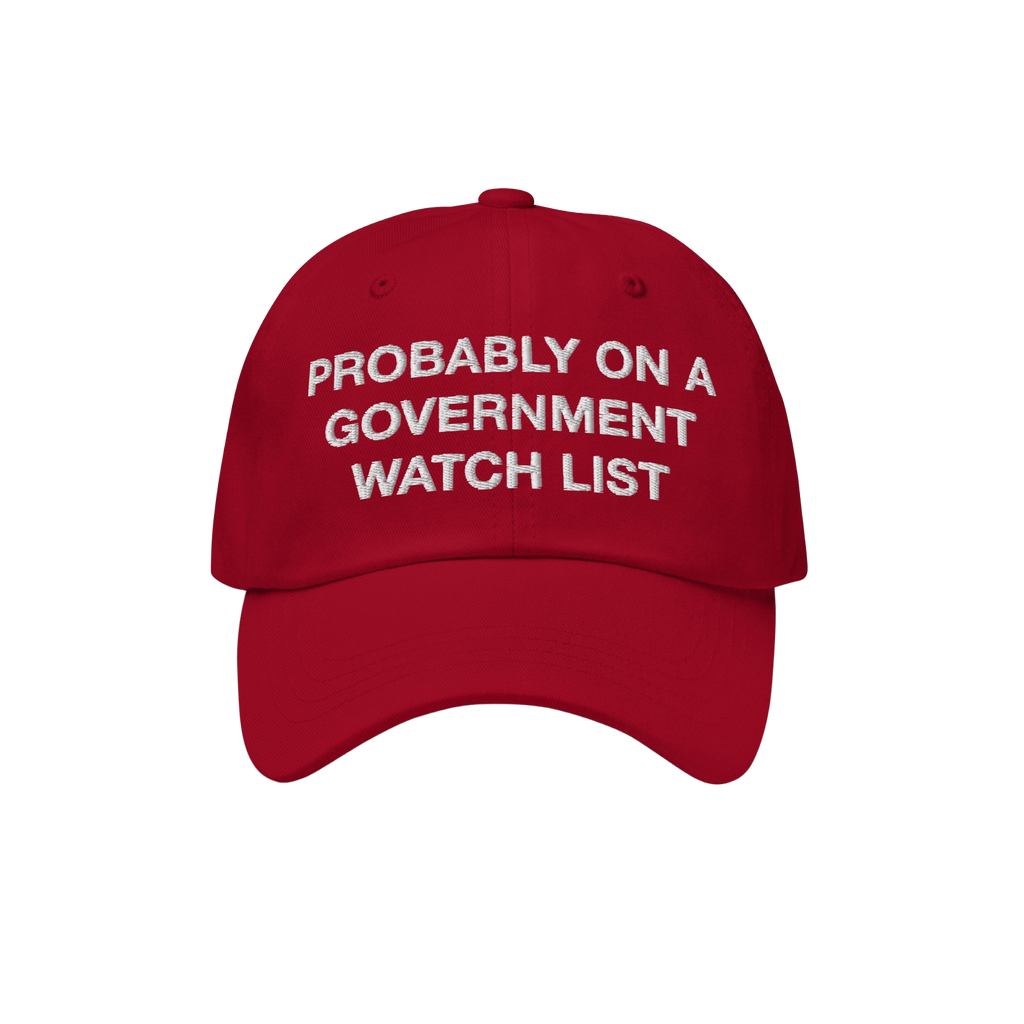 Watch List Hat featuring bold white embroidery with the phrase Probably on a Government Watch List, on a bright red baseball 