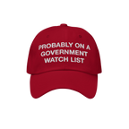 Watch List Hat featuring bold white embroidery with the phrase Probably on a Government Watch List, on a bright red baseball 