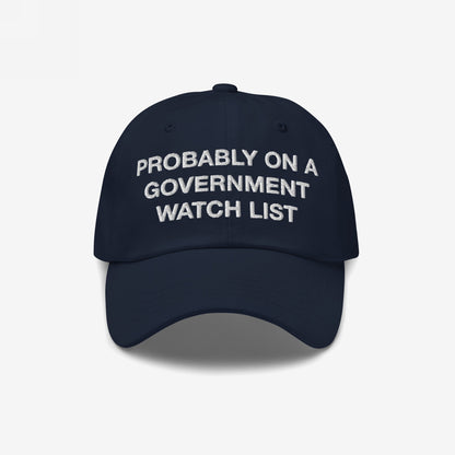 A dark navy blue Watch List Hat with bold white embroidery stating, PROBABLY ON A GOVERNMENT WATCH LIST, conveying a bold protest message for those who advocate for social justice and visibility.