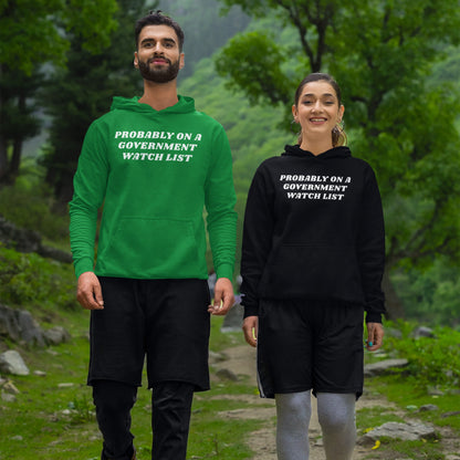 Two young adults wear Watch List Hoodie & Sweatshirt with bold text, PROBABLY ON A GOVERNMENT WATCH LIST, while walking on a forest trail, embodying defiance and advocacy for equality.