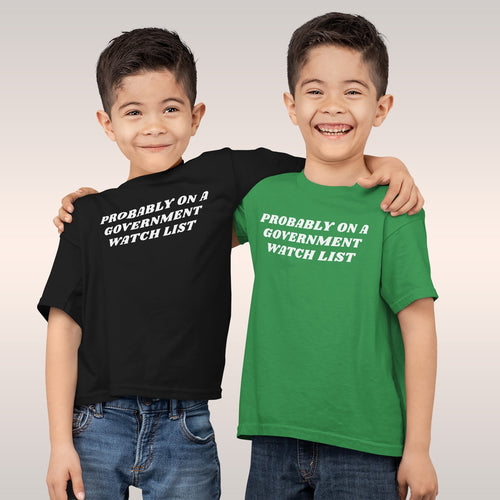 Two young boys embrace, wearing Watch List T-shirts with PROBABLY ON A GOVERNMENT WATCH LIST slogan, embodying defiant spirit
