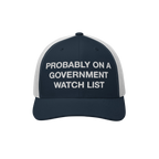 The Watch List Hat features a navy-blue trucker style with white mesh panels, showcasing PROBABLY ON A GOVERNMENT WATCH LIST 