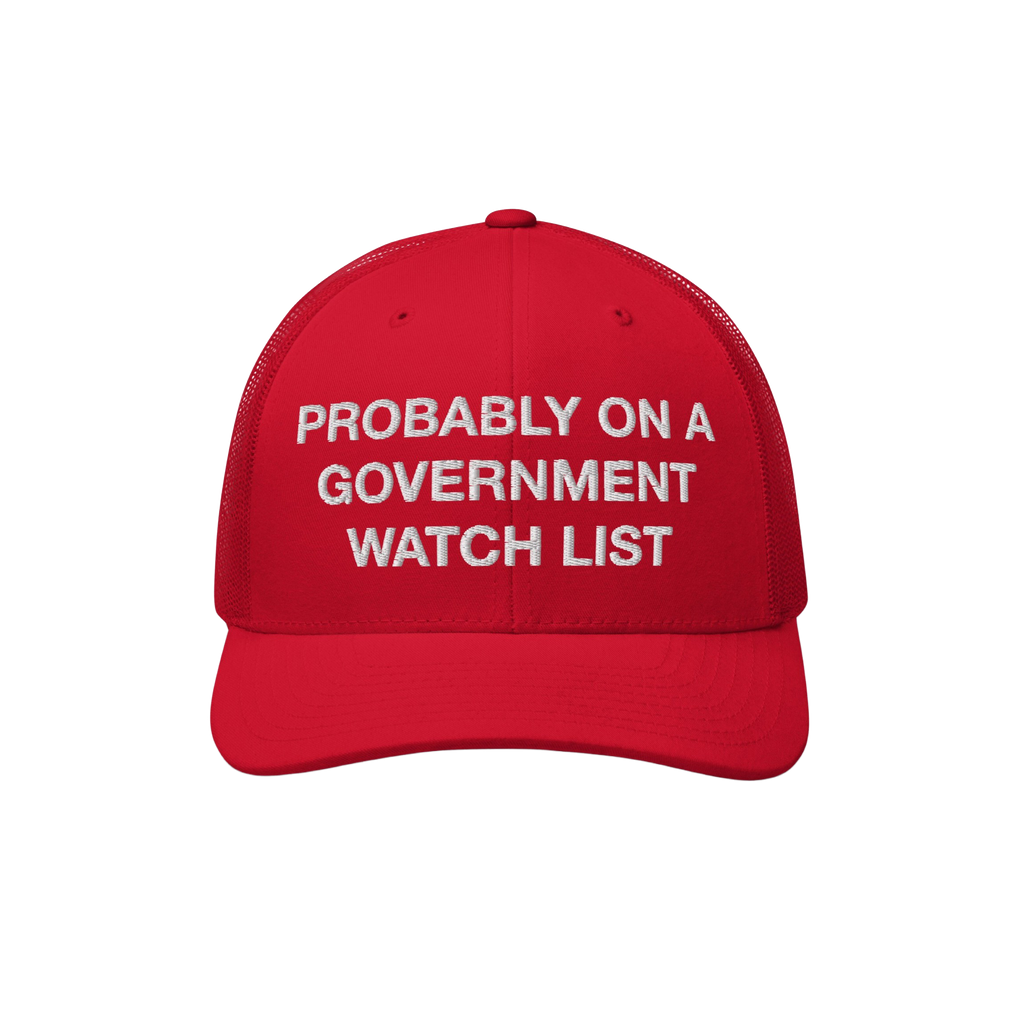 Red trucker-style baseball cap titled Watch List Hat with white embroidered text: “PROBABLY ON A GOVERNMENT WATCH LIST,” 