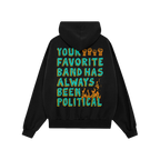 The Your Favorite Band Has Always Been Political shirt's back features teal-and-yellow text with orange raised fists and flam