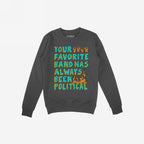 Dark charcoal-gray crewneck sweatshirt with a slogan, “YOUR FAVORITE BAND HAS ALWAYS BEEN POLITICAL,” in turquoise and yellow, featuring raised orange fists and flames, embodies rebellious spirit and political activism.